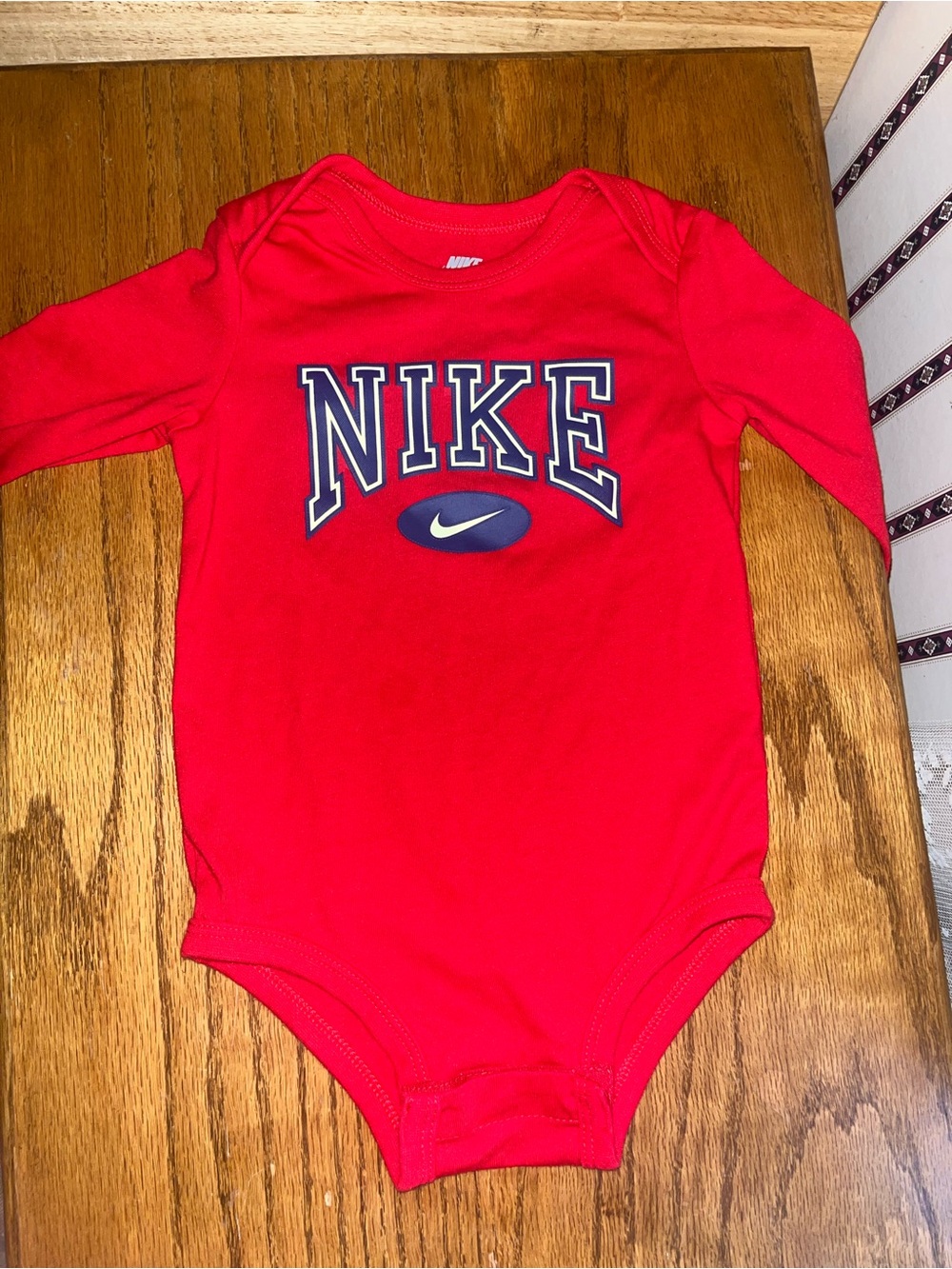 Nike Red Long-Sleeve Baby Bodysuit with Navy Logo